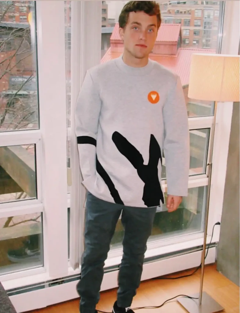 Jordan Elsass in Foxylab New York grey sweatshirt with modern black and white graphic design