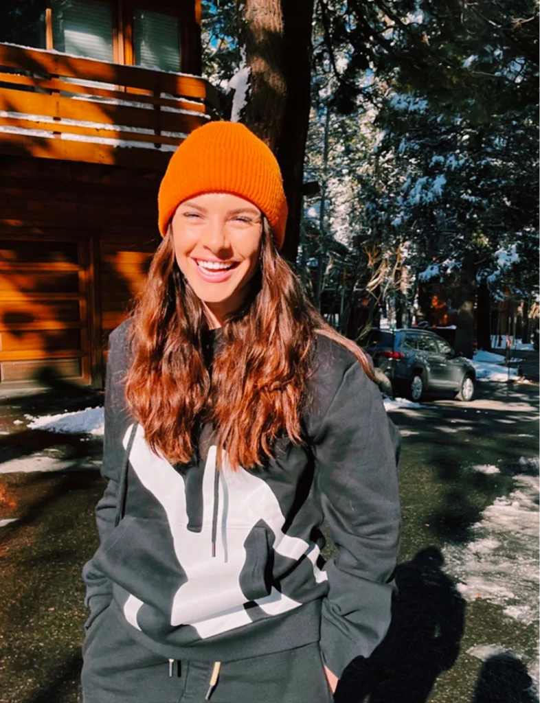 Brooke Chamberlain styling Foxylab New York black hoodie with bold white streetwear print and orange beanie.