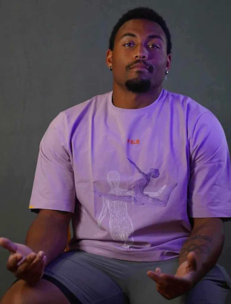 Curtis Thompson in Foxylab New York lilac t-shirt with minimalist graphic print