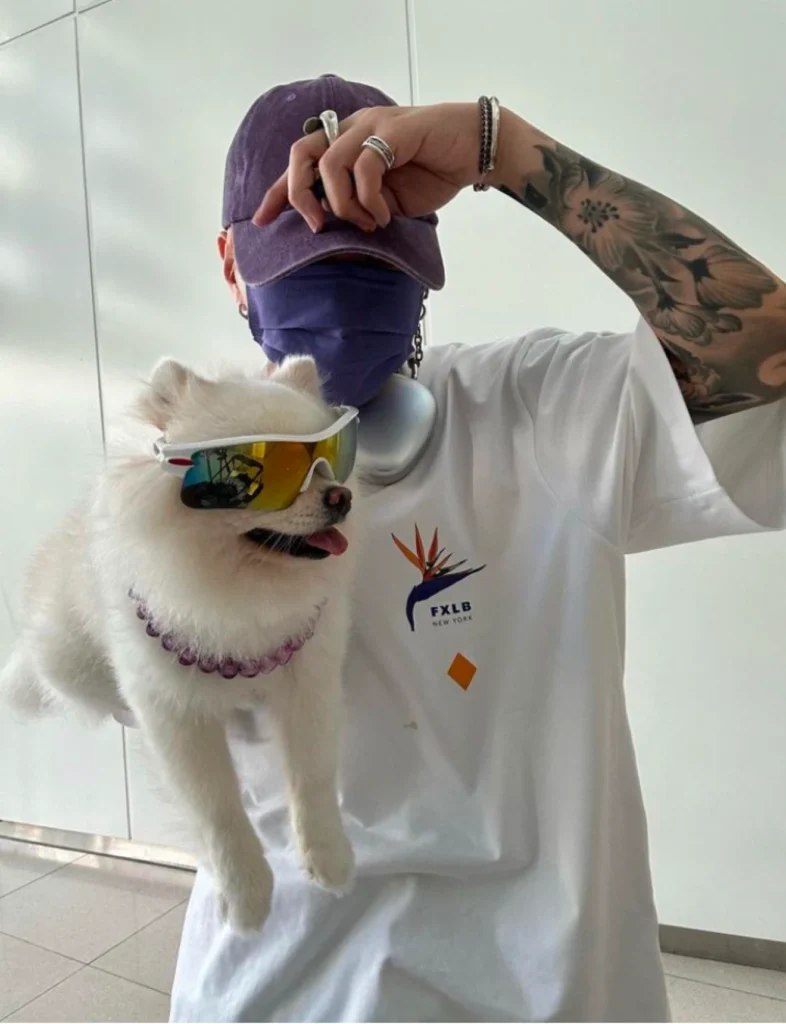 Yeung K C Milk in Foxylab New York white streetwear t-shirt holding a Pomeranian dog in sunglasses