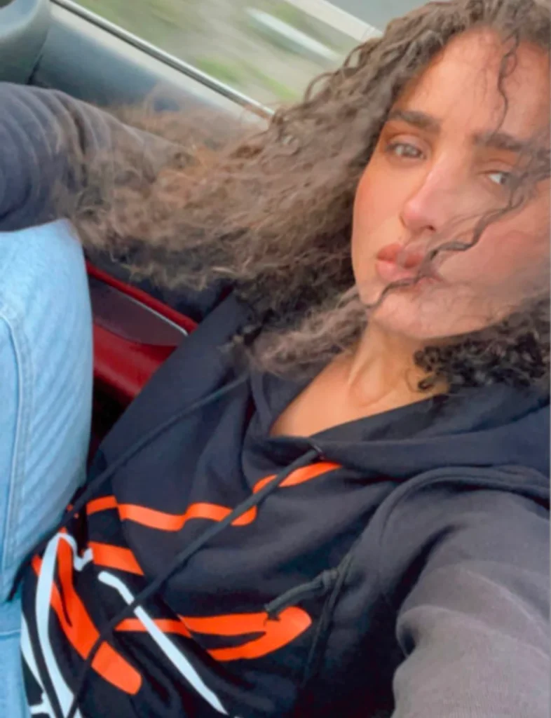 Sara Bellak wearing Foxylab New York black hoodie with bold orange streetwear graphic