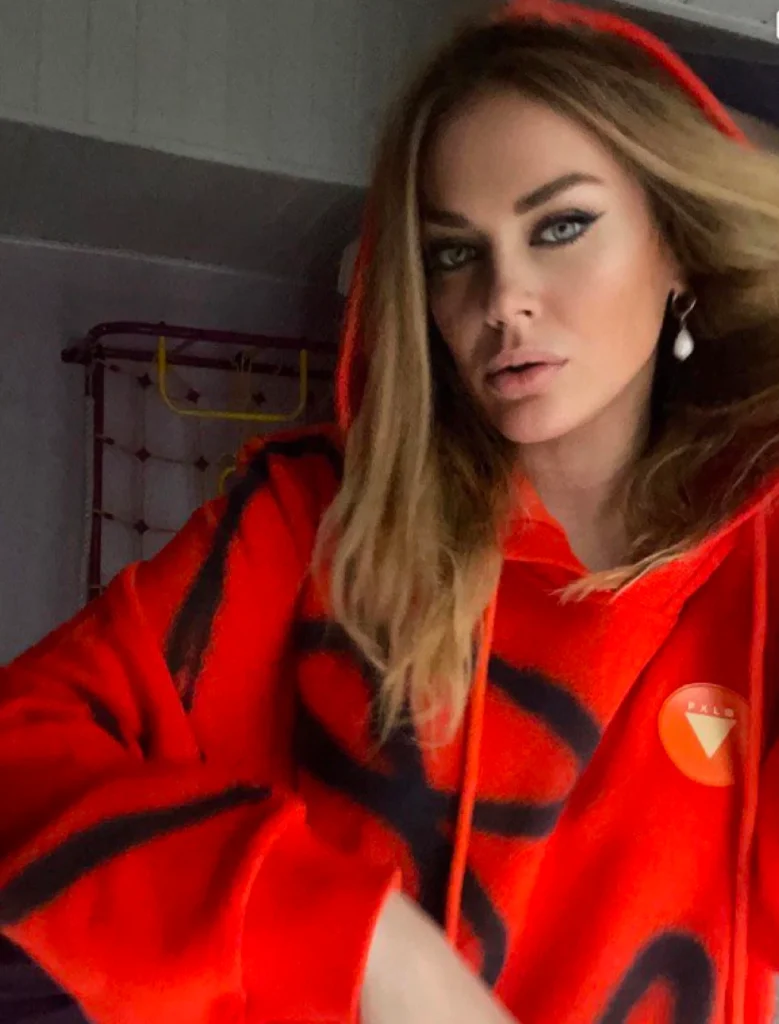 Tanya Tereshina wearing Foxylab New York bright red hoodie with oversized black streetwear graphic