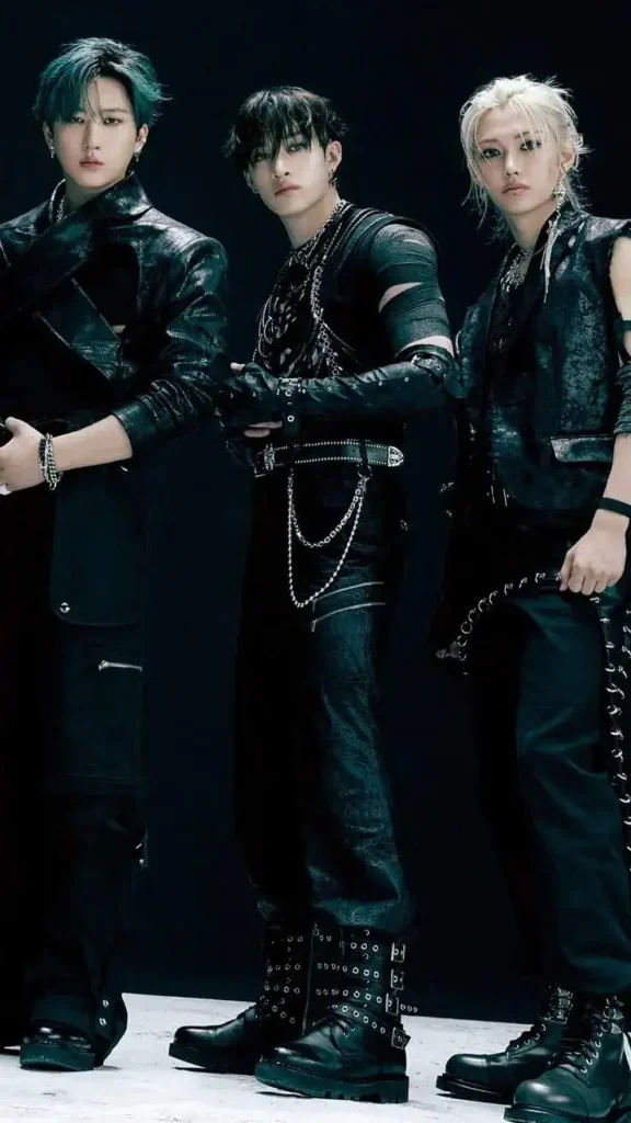 3 kpop singers wearing edgy rocky outfits, stylish shoes.