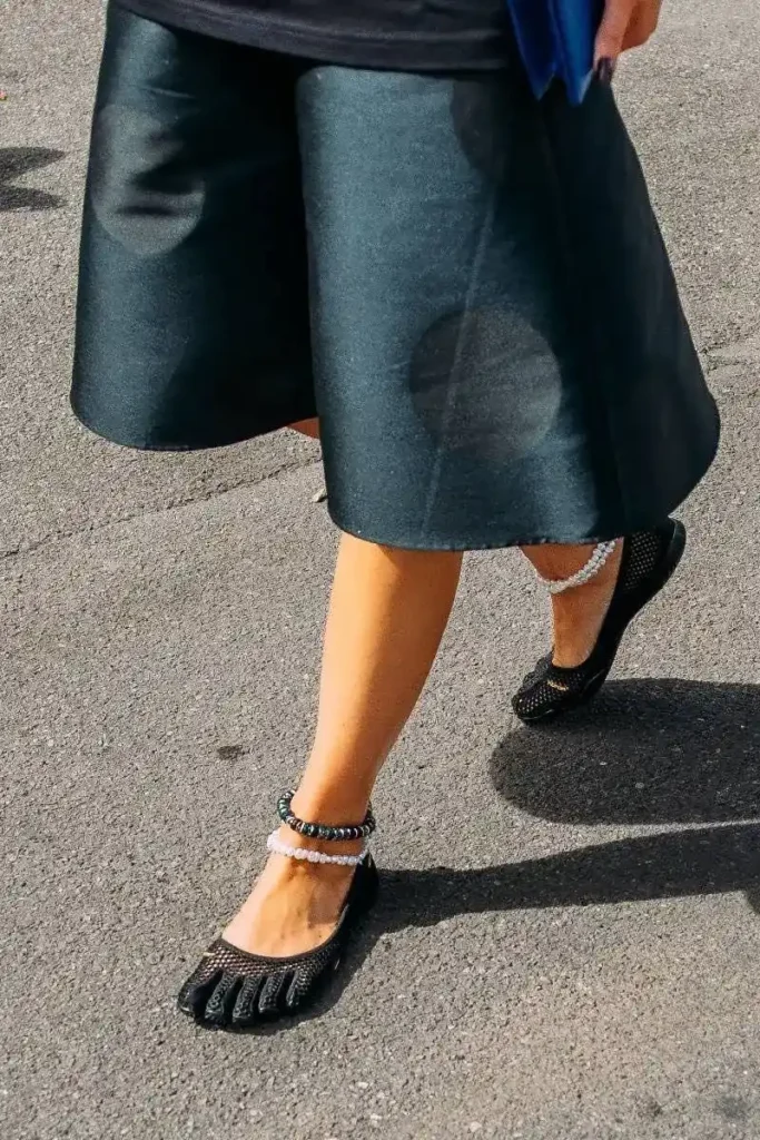 Barefoot shoes paired with a stylish outfit, combining comfort and street style innovation.