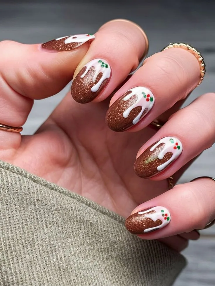 A female hand displaying nail art in brown.
