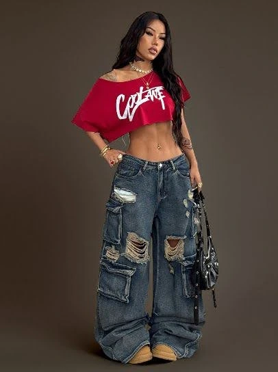 Woman in a "baddie" aesthetic outfit: red cropped top, distressed baggy jeans, and heels.
