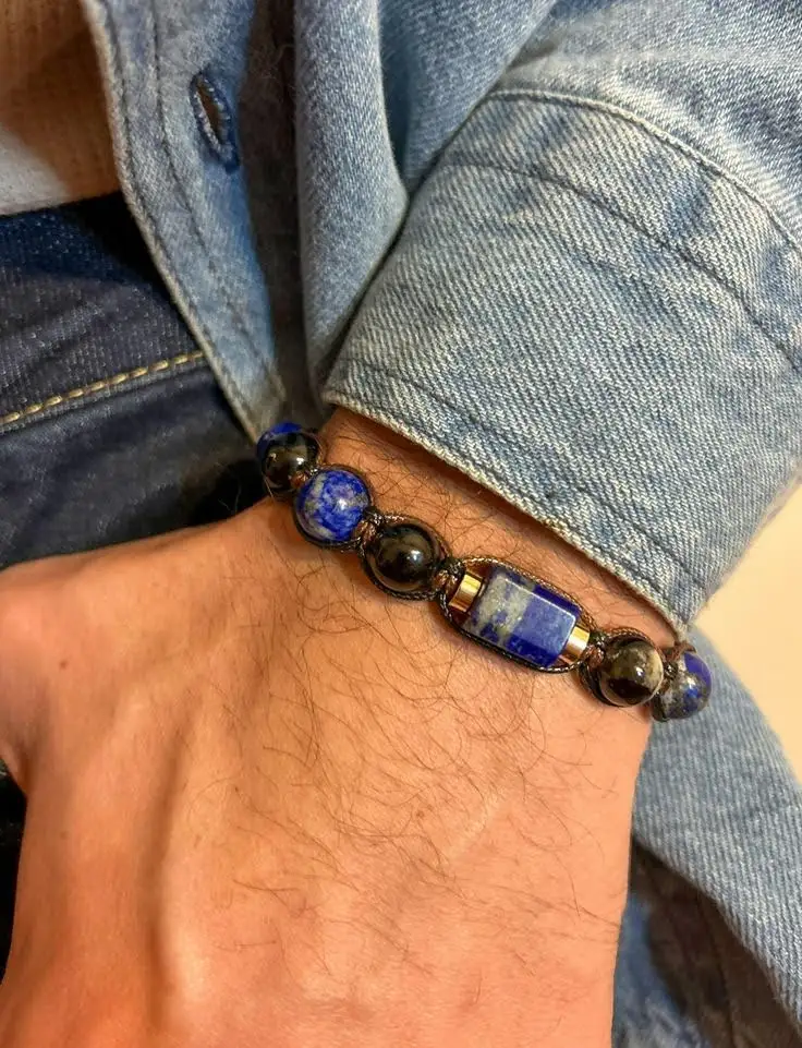 A man is wearing a natural stone bracelet.