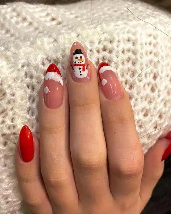 A female hand showing nails with Christmas nail art.