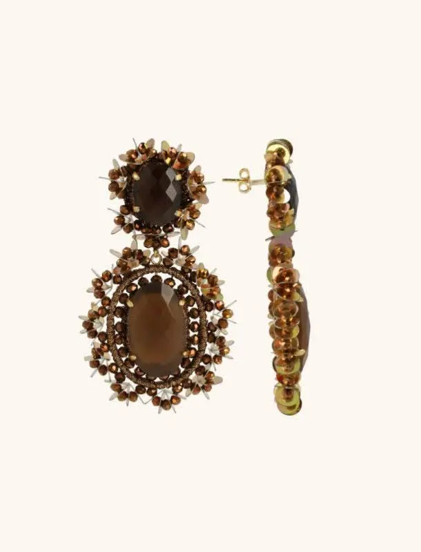 A set of gemstone earrings on a flat surface.