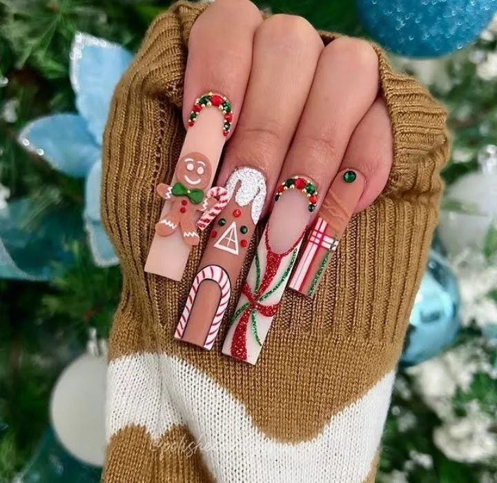 A female hand showing long nails with house nail art.