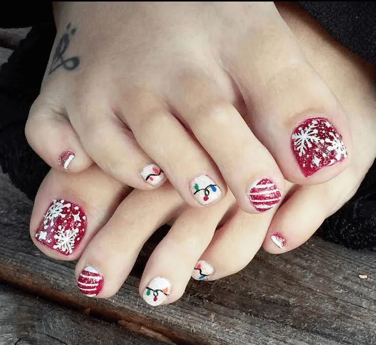 A female's toenails showing festive nail designs.