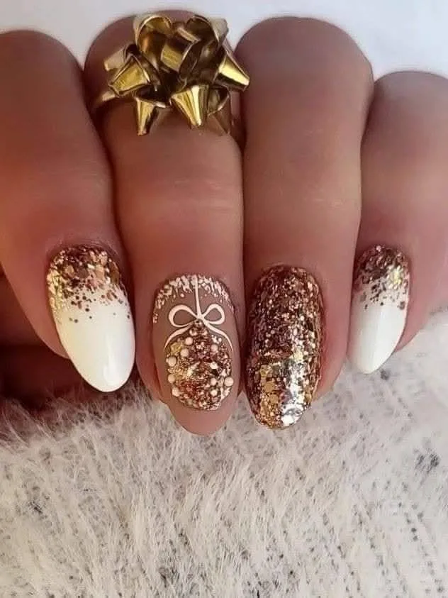 A female hand showing nails with glitter nail art.