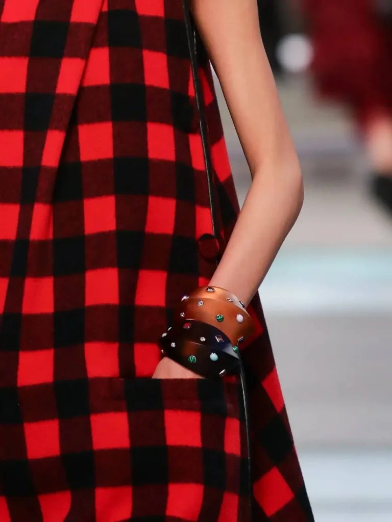 A runway actress hand with trendy fall cuffs.