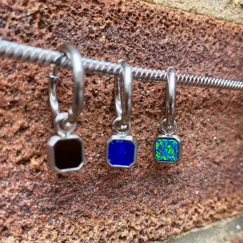 It shows three different types man's earrings.