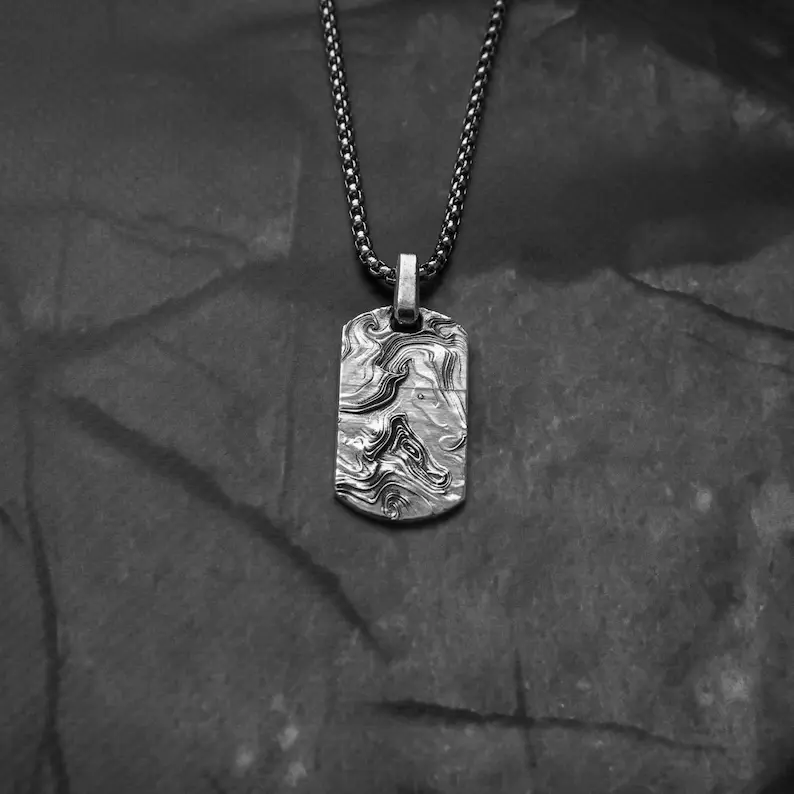 It shows men's abstract necklace.