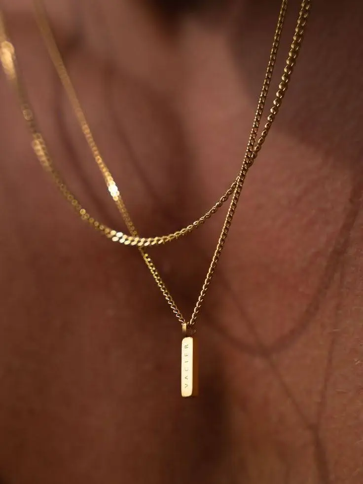 A man's chest with two different minimalist .chains
