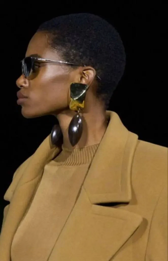 A woman wearing bold gemstone jewelry.
