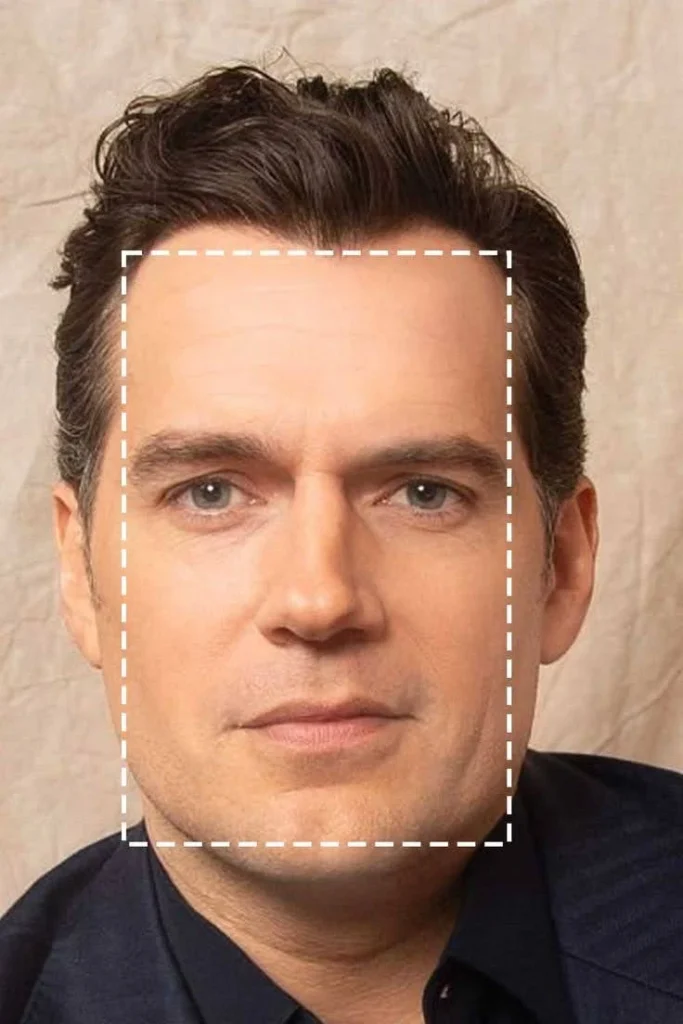 A close-up of Henry Cavill's face, with a white dashed square highlighting his square face shape.