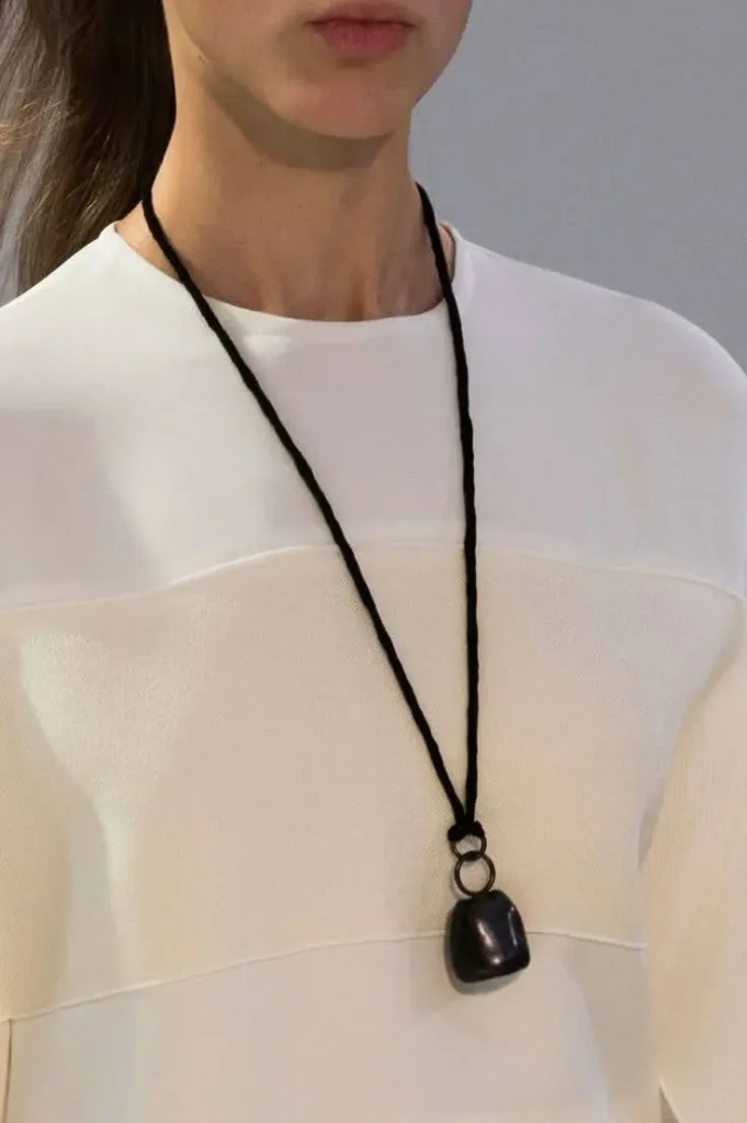 A woman with a leather cord necklace.