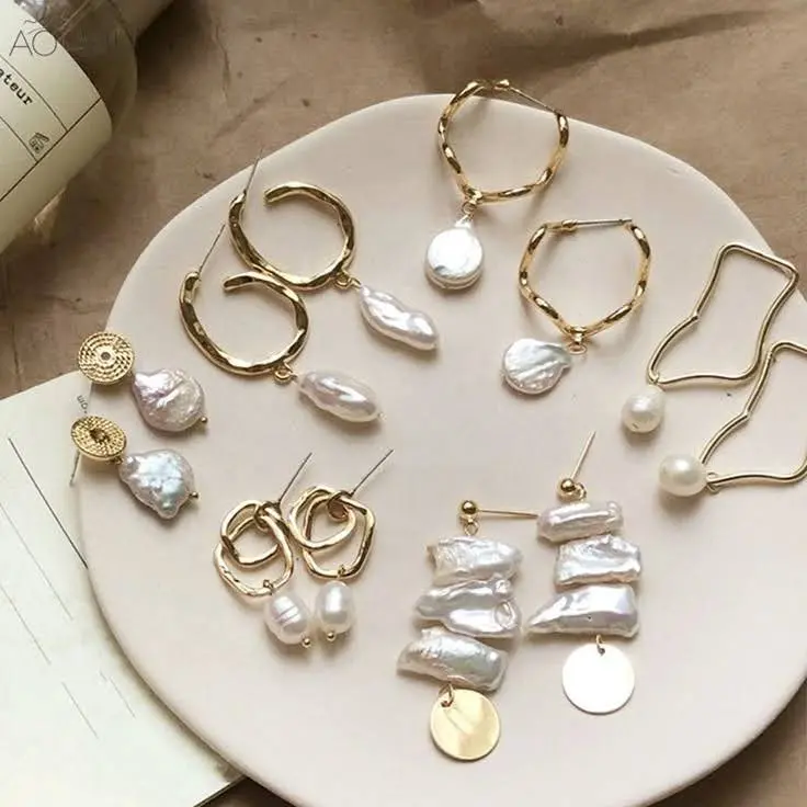 A plate with 7 different pairs of baroque pearl earrings.