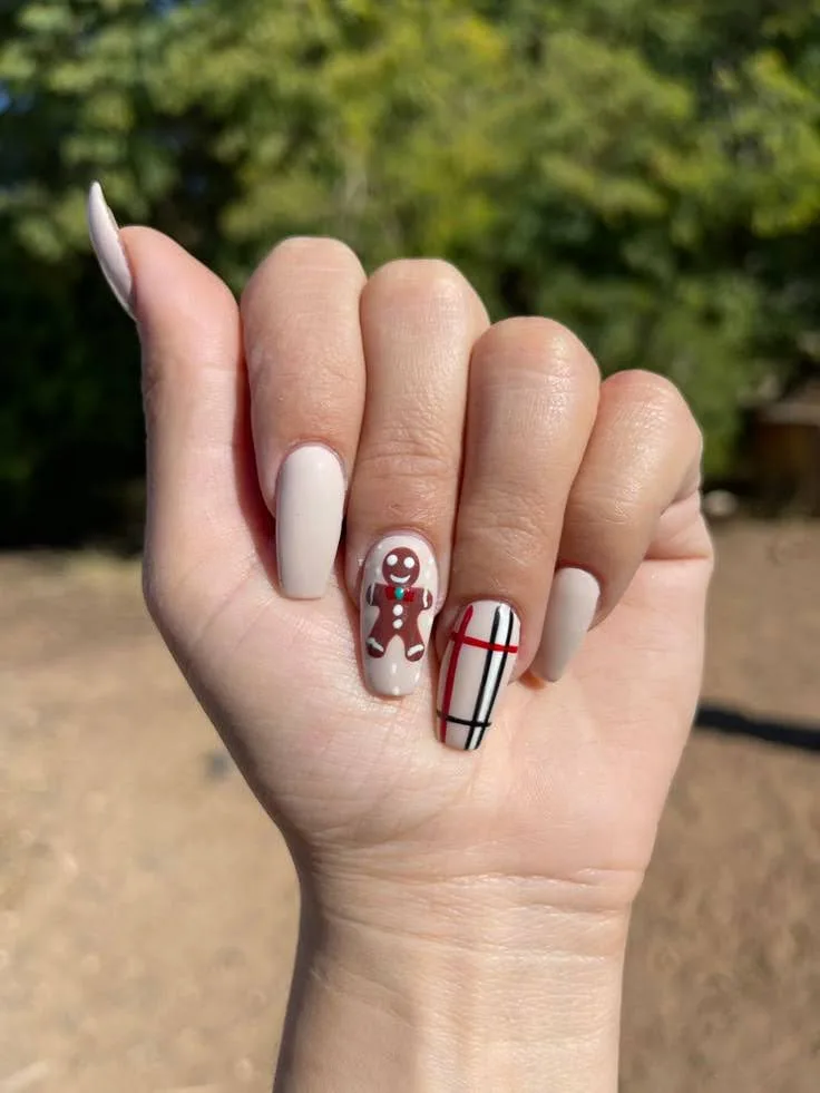 A female hand showing plaid nails .