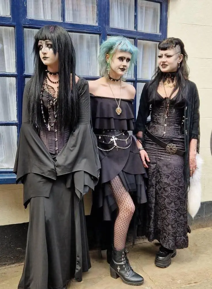 3 different girls with trad goth style dresses