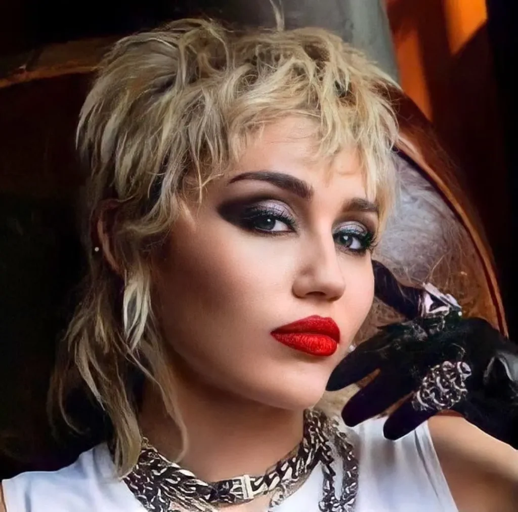 An actress with a stylish wolf cut hairstyle with color