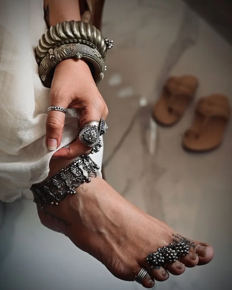 A girl wearing old traditional rings on toes.