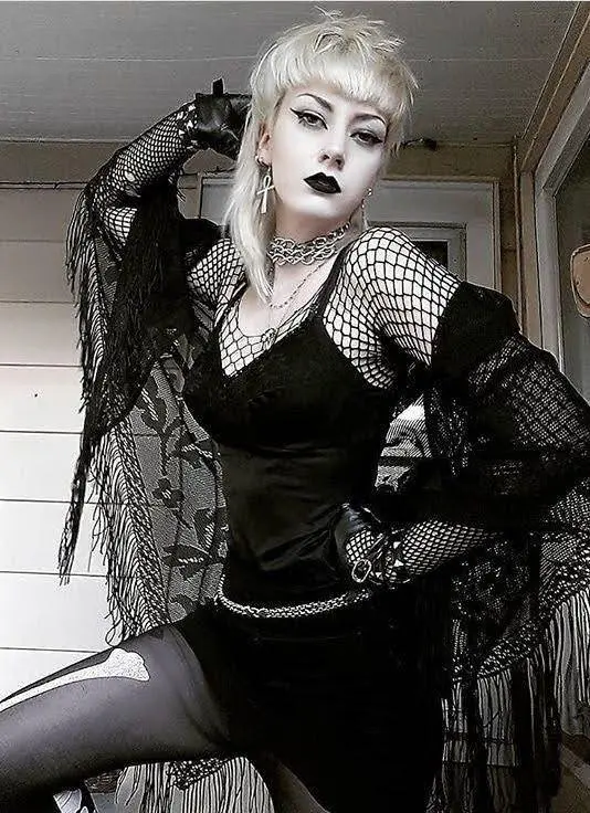 A girl posing in trad goth dress.
