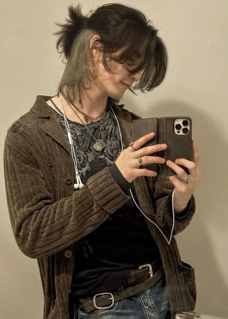 A boy with long wolf cut .