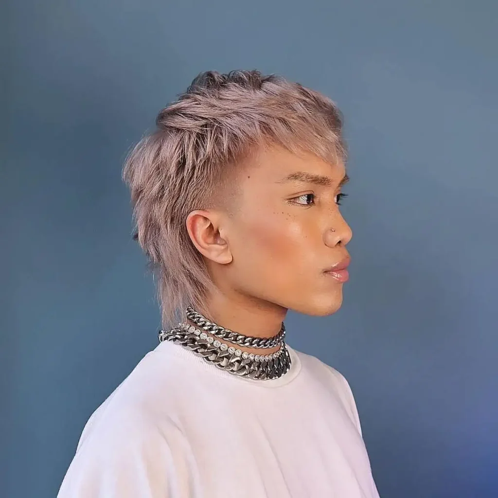 a boy with a mullet wolf cut hairstyle.