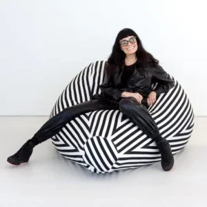 Norma Kamali sitting on the couch.