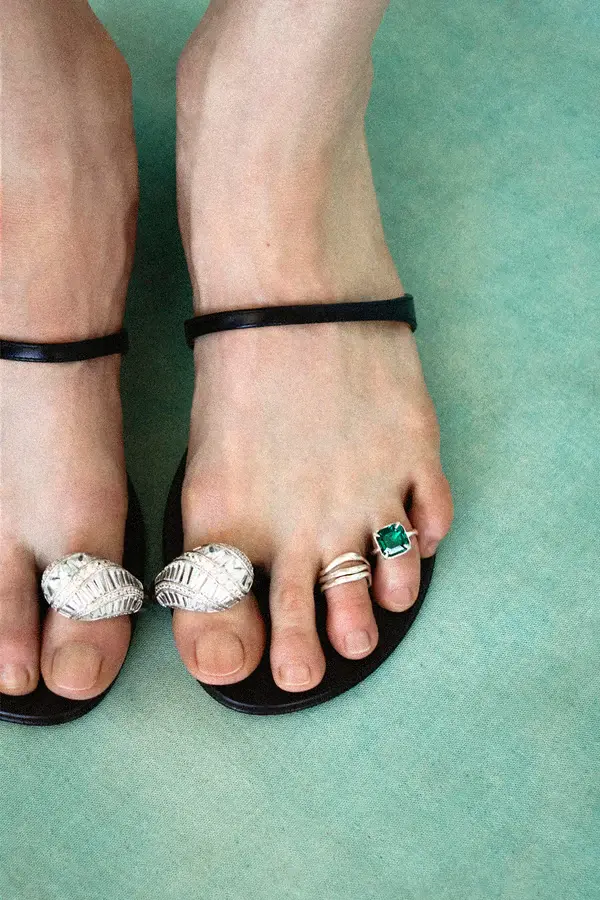 A woman toes with stunning different silver rings.