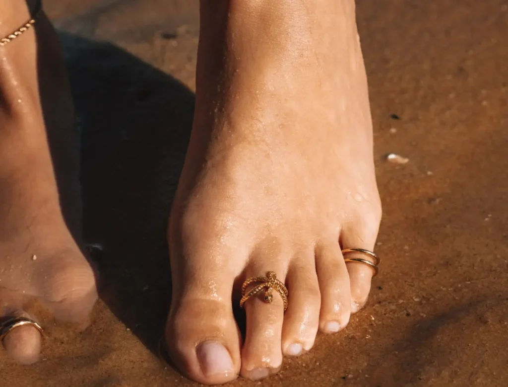 a girl with two different adjustable gold toe rings.