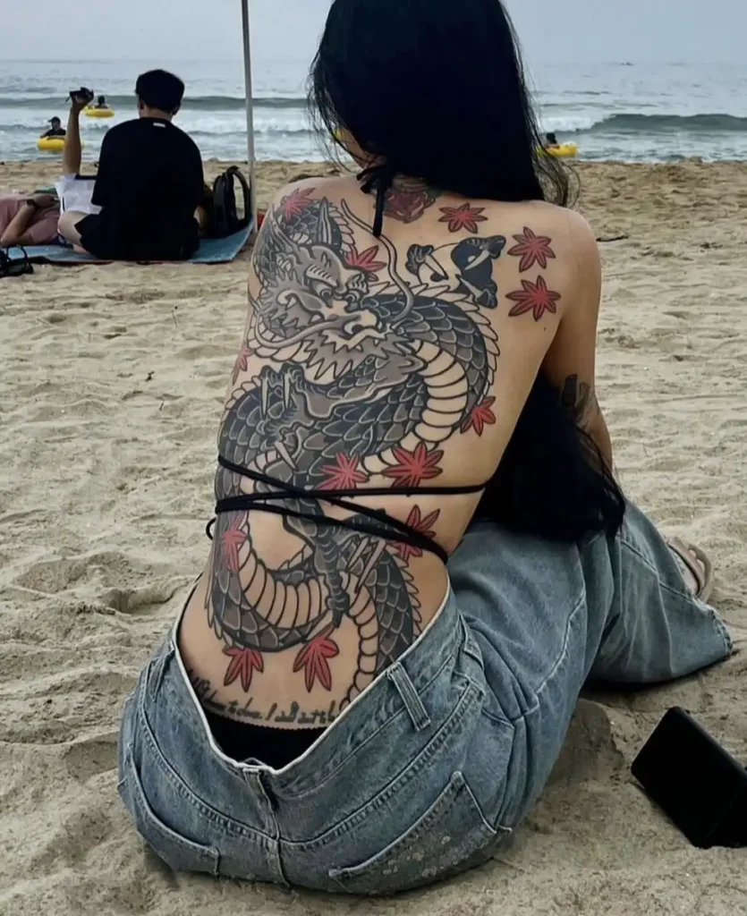 A girl has a yakuza tattoo on her back