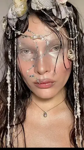 An actress with stylish sea-like beaded makup