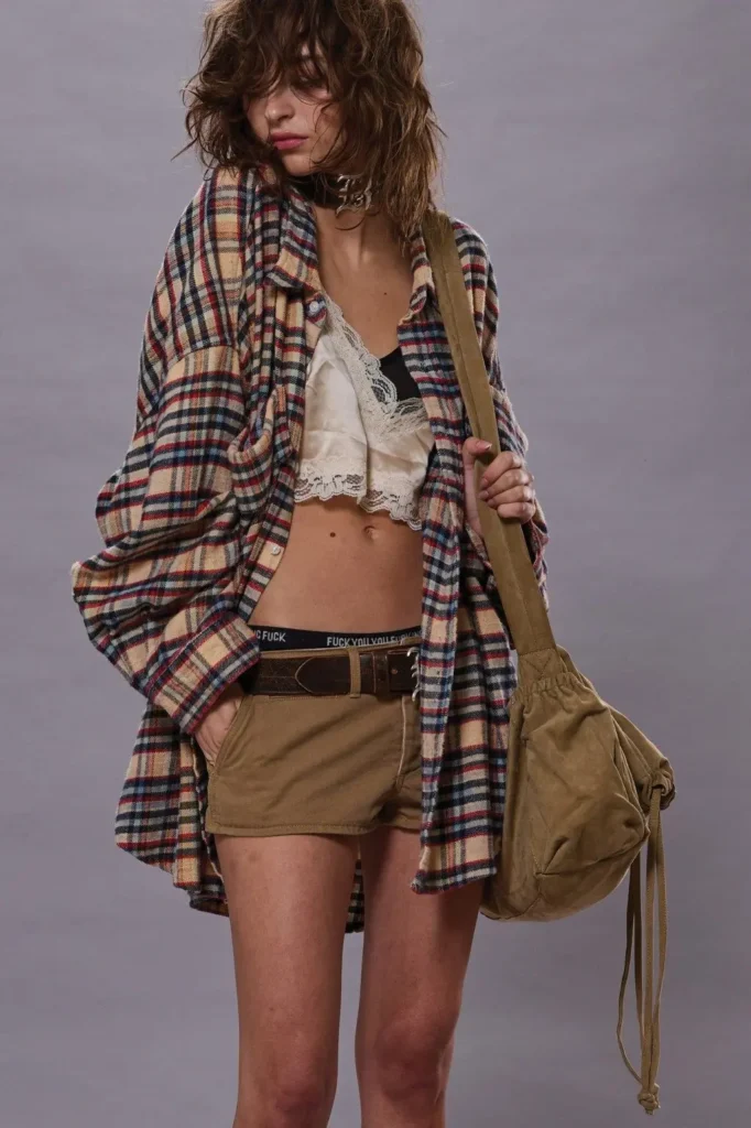 A girl is wearing grunge style clothes.