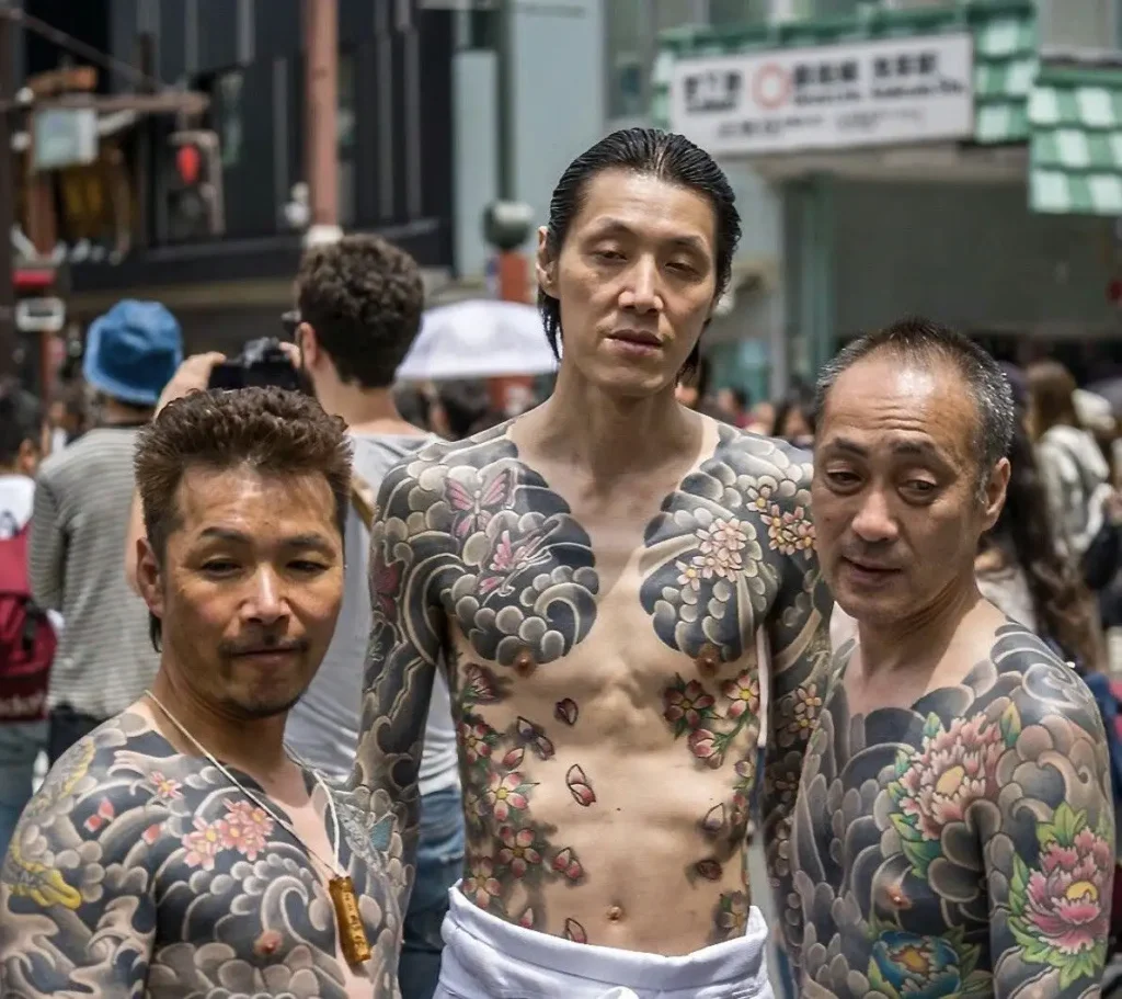 3 men with Iruzmi tattoos on body its showing history