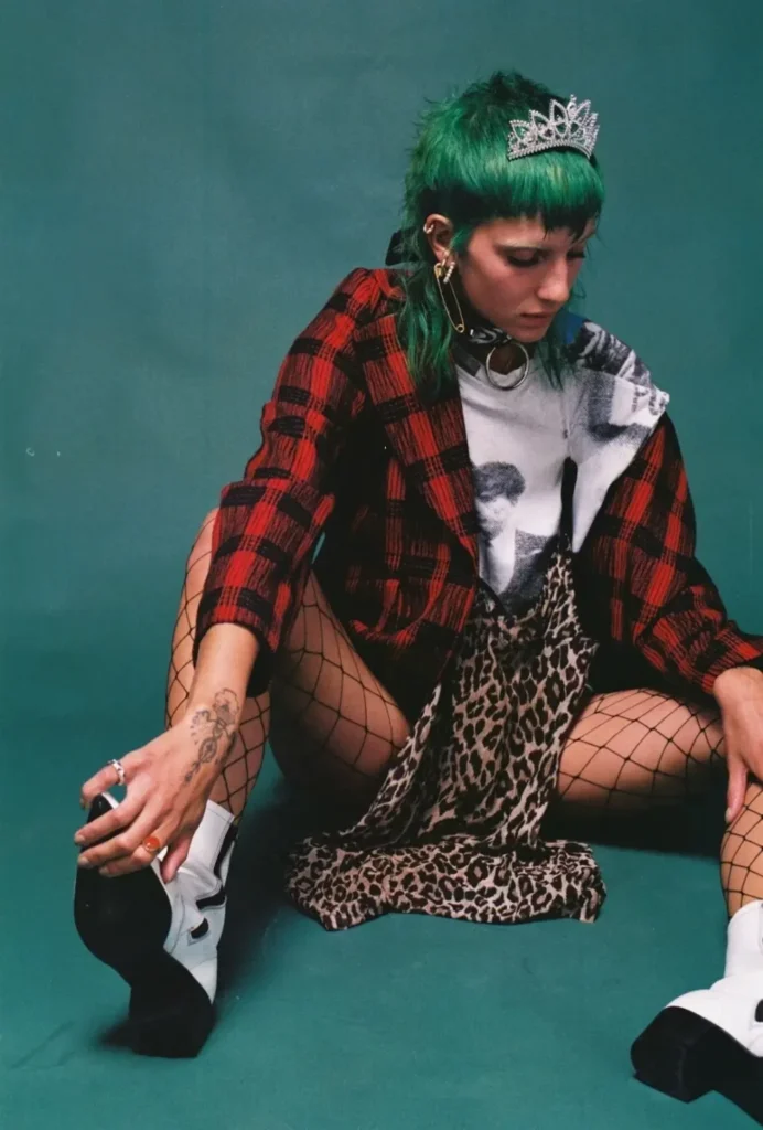 a girl sitting on the floor with a stylish pose