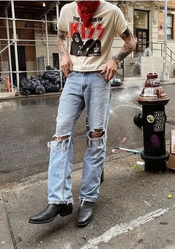 classic grunge look of a boy who is standing in the road