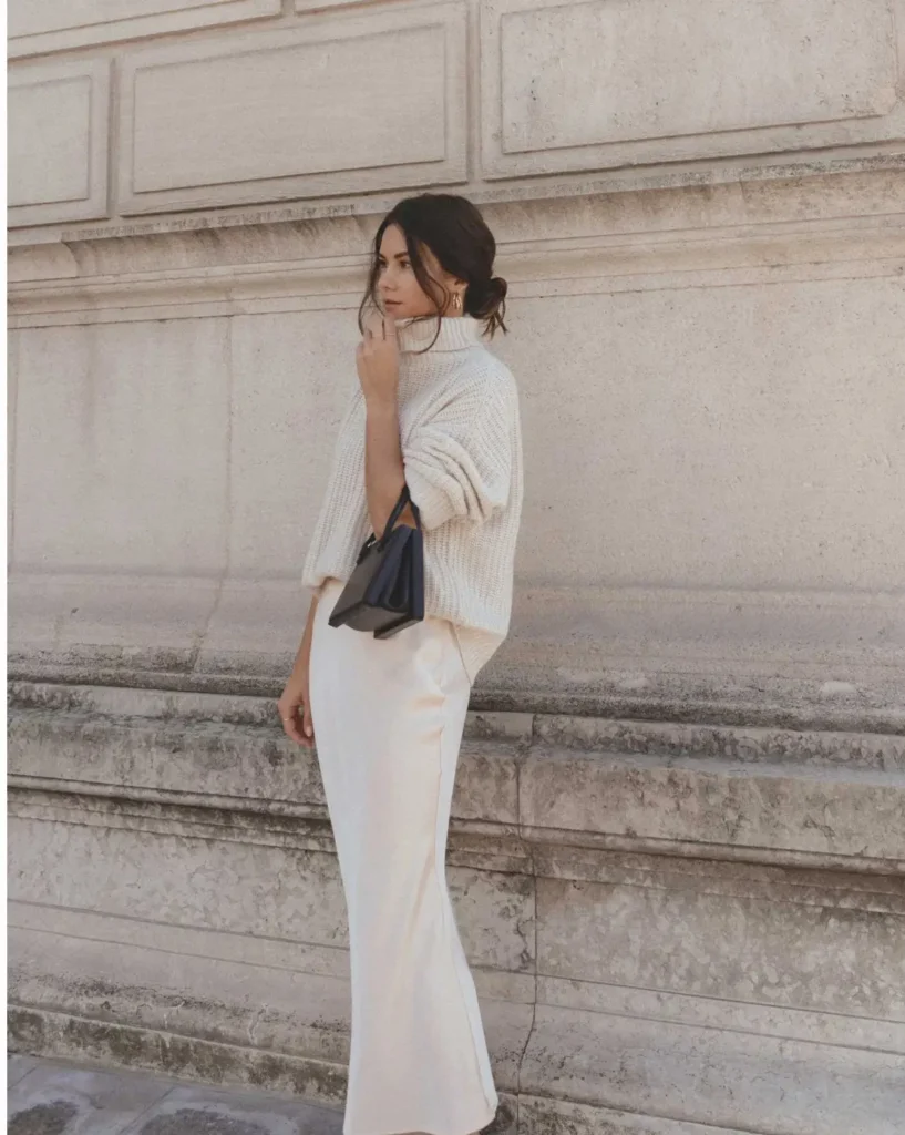 a girl wearing a trendy winter 2025 style dress and cashmere sweater