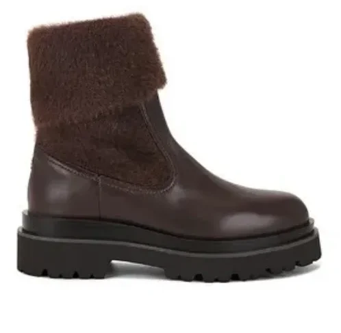 Brown Suede boots on flat surface