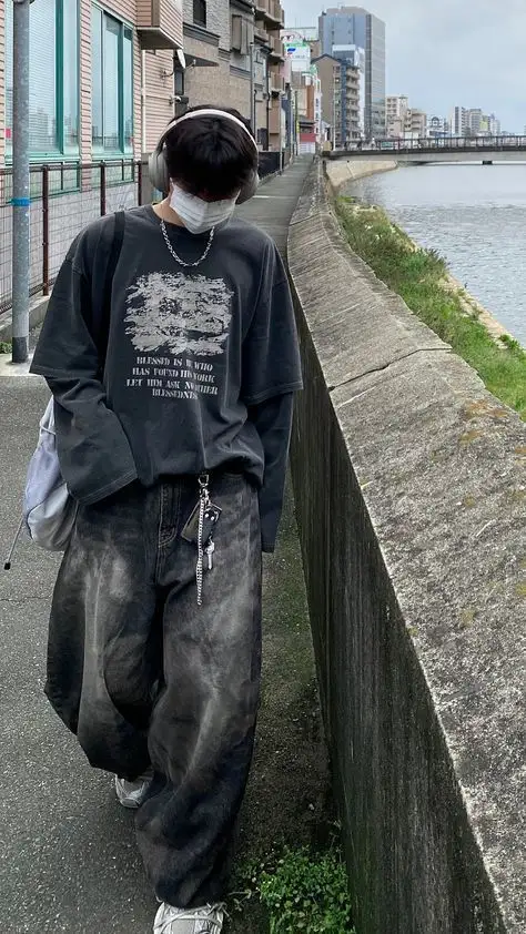 a boy is in the street with a street style grunge aattire