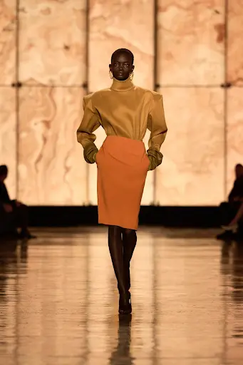 a model on ramp wearing trending fall skirt dress