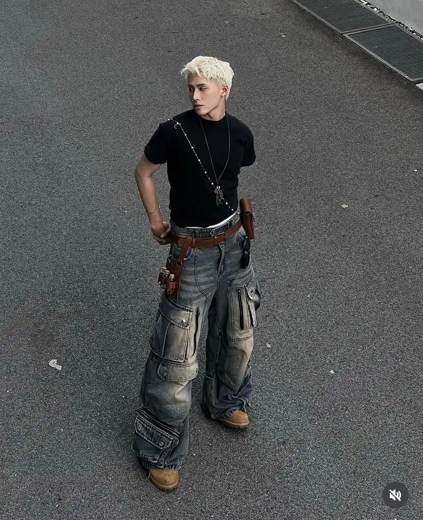 A boy is standing in middle of the road in y2k grunge dress