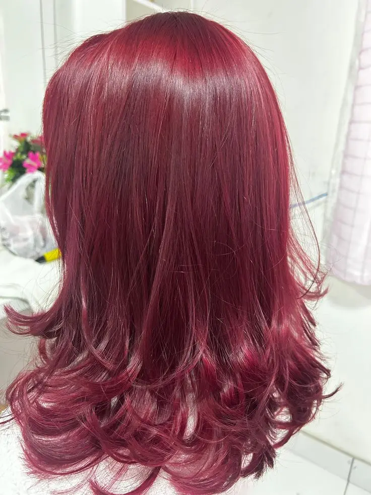 a girl head with shinny red mirror cherry red color dye