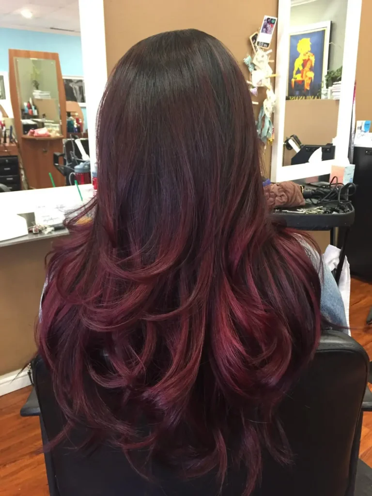 a girl back look showing cherry red hair dye