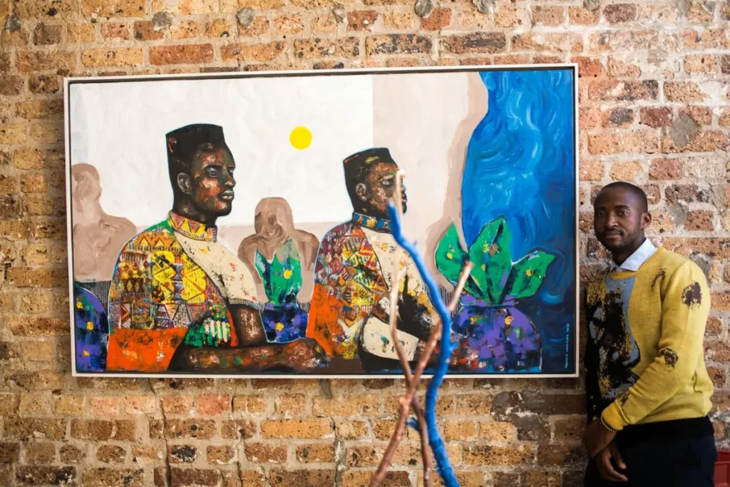 Buhle Nkalashe artist From South Africa standing close to his painting