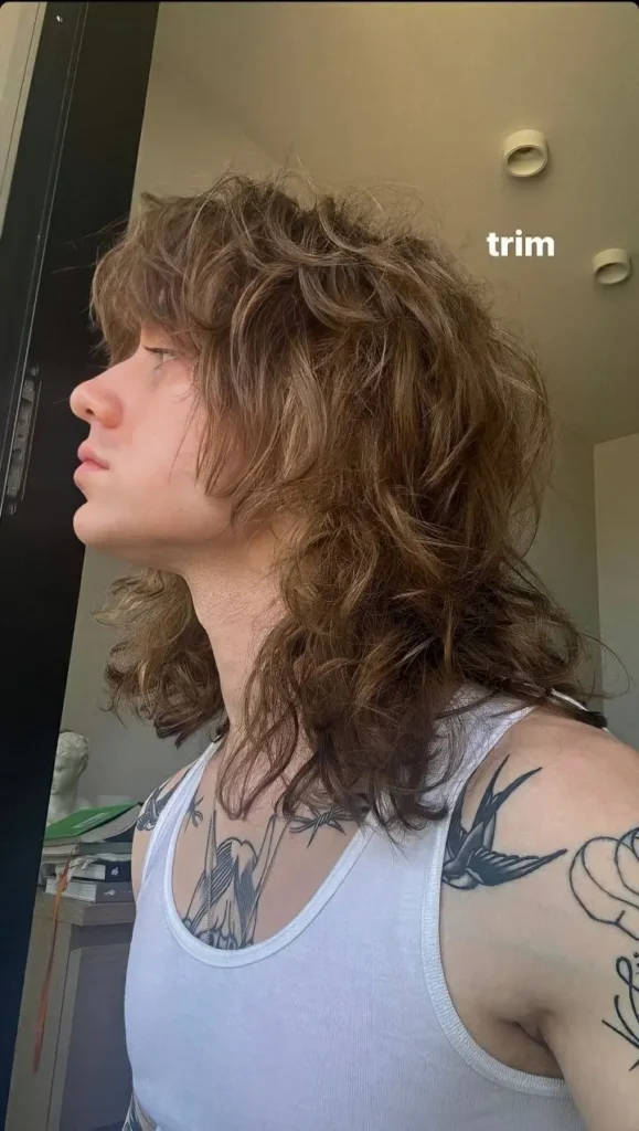 a boy with long mullet haircut