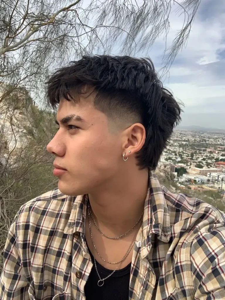 a boy with short mullet haircut